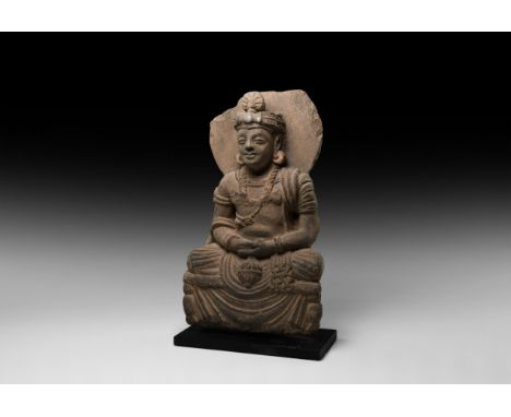 2nd-3rd century AD. A schist figure of Buddha sitting cross-legged with a censer in his lap,&nbsp;crested turban and aureole 