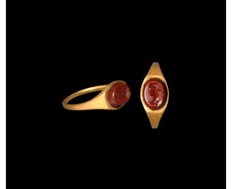 1st century AD. A gold finger ring with carnelian gemstone, intaglio profile female bust. Cf. Chadour, A.B., Rings. The Alice