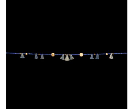 Late New Kingdom, 1550-1070 BC and later. A restrung necklace composed of oblate lapis lazuli beads interspersed with small f