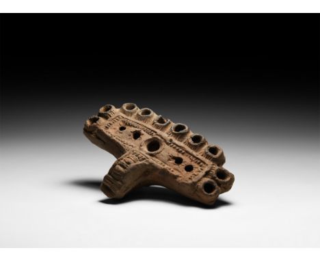 3rd century AD. A ceramic rectangular lamp with ten nozzles arranged around the rim of the body, lug handle with billet detai