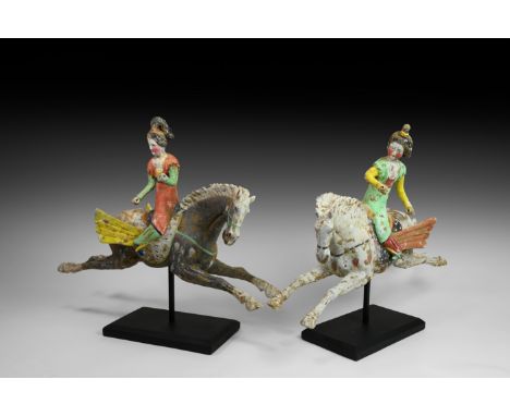 Tang Dynasty, 618-906 AD. A substantial pair of ceramic figurines each depicting a female polo player with piled hairstyle, t