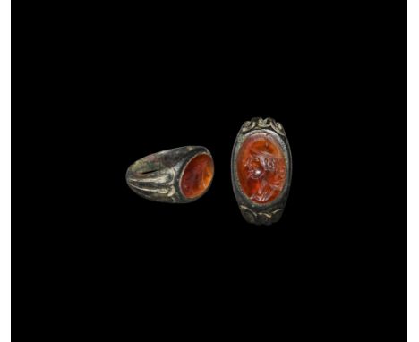 2nd-3rd century AD. A silver ring with fluted shoulders, inset carnelian cloison with intaglio profile bust of Mars (Greek Ar