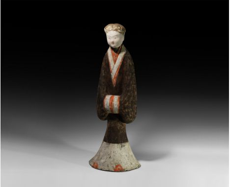 Han Dynasty, 206 BC-220 AD. A hollow-formed ceramic figurine of a courtly lady with trumpet-shaped base, floor-length gown wi