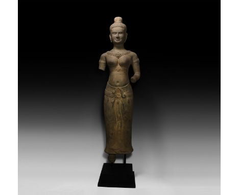 10th-12th century AD. A carved sandstone statue of Lakshmi in samabhanga pose with sampot and ornate collar, hair gathered in