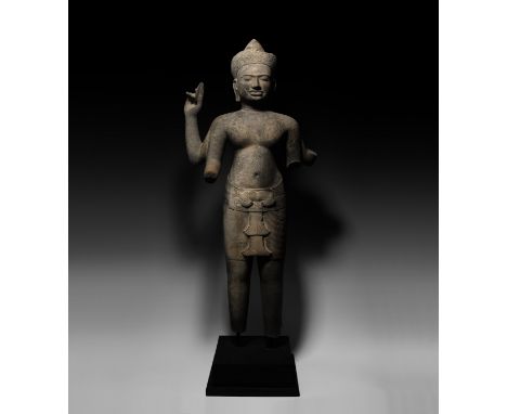 10th-12th century AD. A carved basalt statue of Vishnu in vigilant pose with pleated sampot and ornamental knotted cord, flou