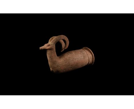 1st millennium BC. A terracotta rhyton with tubular body and everted rim, a collar beneath the rim; the finial an ibex head w