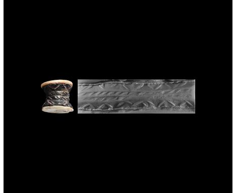 3rd-2nd millennium BC. A cotton reel-shaped cylinder seal decorated with a linear pattern, applied mother of pearl cap to eac