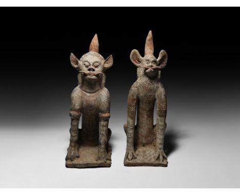 Tang Dynasty, 618-906 AD. A mixed pair of ceramic figures, each a crouching mythical creature with human facial features.  8.