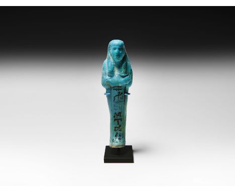 19th-20th Dynasty, 1295-1077 BC. A glazed composition shabti with black painted detailing including the tripartite wig, agric