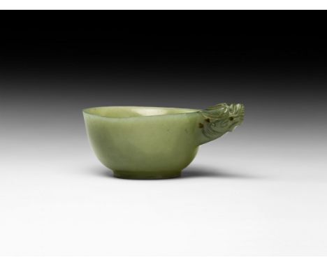 Qianlong Period, 18th century AD. A carved translucent jade cup with pierced handle formed as the head of a dragon. 64 grams,