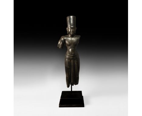 9th-11th century AD. A carved black limestone statue of Vishnu in belted sampot with kirita-mukuta headdress, four arms sprin