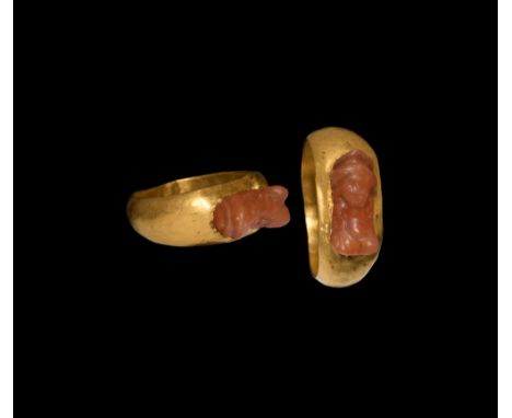 2nd century AD. A hollow-formed gold ring with D-section hoop and expanding shoulders, with a carved carnelian bust of Minerv