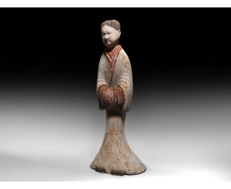 Han Dynasty, 206 BC-220 AD. A hollow-formed ceramic figure of a standing female attendant in a floor-length robe, her hands e