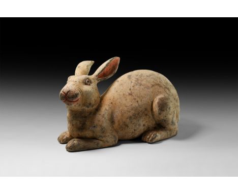 Han Dynasty, 206 BC-220 AD. A ceramic figure of a rabbit with painted detailing to the eyes, nose and ears.  2.8 kg, 28cm (11