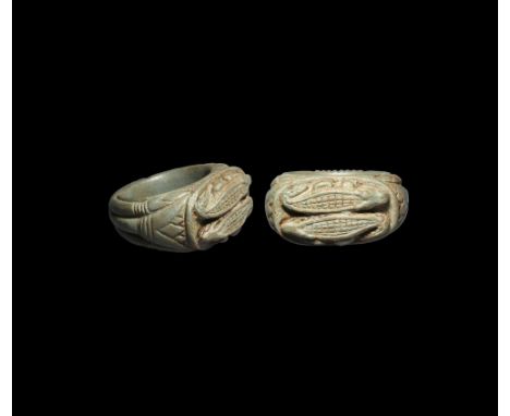 Late New Kingdom, 1550-1070 BC. A steatite finger ring with papyrus stalk detailing to the shoulders, plaque with a pair of c