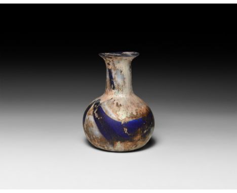 3rd-4th century AD. A bulbous blue glass bottle with iridescent marbling, dimple base, tubular neck, flared rim. Cf. Whitehou