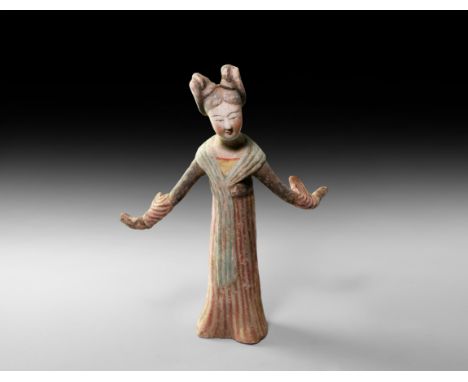 Tang Dynasty, 618-906 AD. A ceramic figurine of a dancing female with arms flung out to the sides in the traditional dance mo