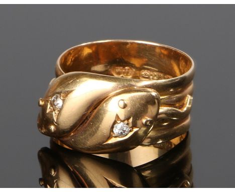 18 carat gold and diamond set double headed snake ring, the snake heads each set with a single diamond, ring size Q 1/2, 6.8g