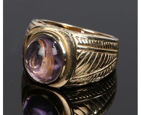 9 carat gold amethyst ring, the oval amethyst flanked by pierced and line decorated shoulders, ring size N 1/2, 7.9g