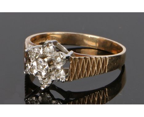 9 carat gold diamond set ring, in the form of  flower head set with diamonds, ring size K 1/2