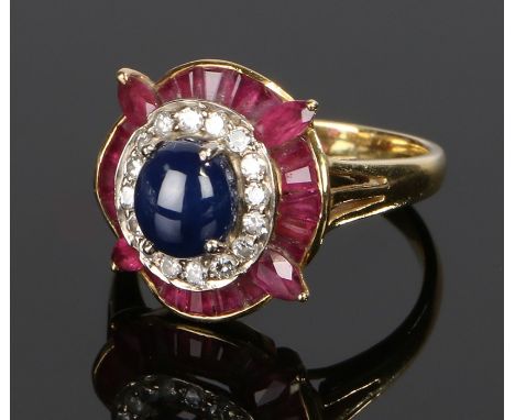 18 carat gold sapphire ruby and diamond set ring, the cabochon sapphire above a surround of diamonds and a surround of rubies