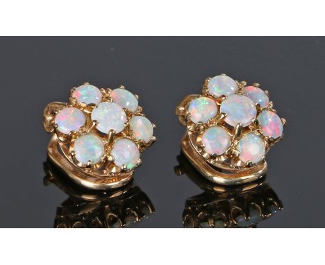 Pair of opal set ear studs, with seven opals forming a flower head, 10mm diameter 