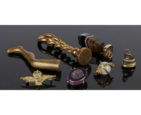 Collection of objects, to include two seals, a banded agate pendant, a snake sphere, a badge a pipe tamper and a seal set to 
