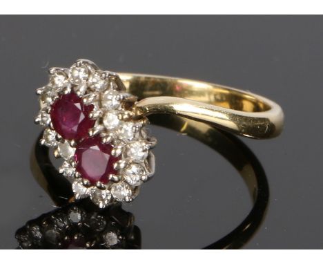 18 carat gold ruby and diamond set ring, with two rubies to the head and a diamond surround, ring size M