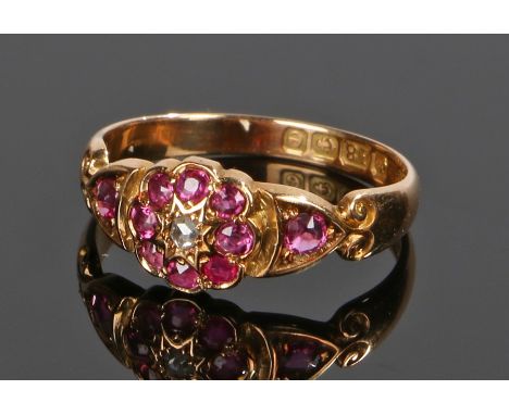 Antique ruby and diamond ring, the central diamond surrounded by a band of rubies and with a ruby to each shoulder, ring size
