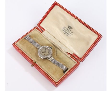 Ladies platinum and diamond set cocktail watch, the dial with Arabic numerals surrounded by a diamond set bezel, manual wound