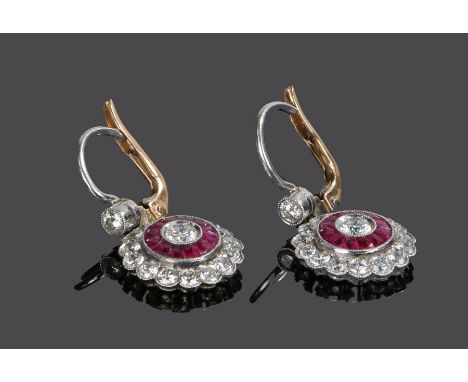 Pair of diamond and ruby earrings, the drops with a central diamond, ruby and diamond surround, 12mm diameter 