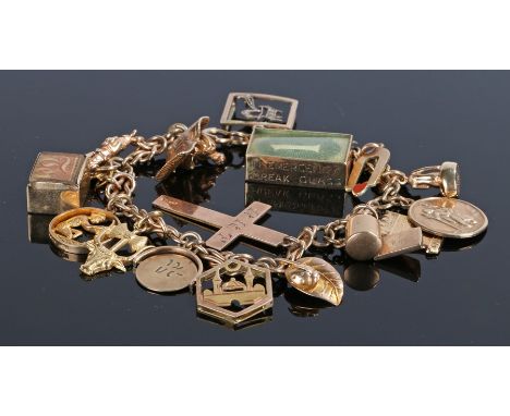 9 carat gold charm bracelet, with various charms to include a cross, a letter R, a carpet, a mosque, etc, 38.4 grams
