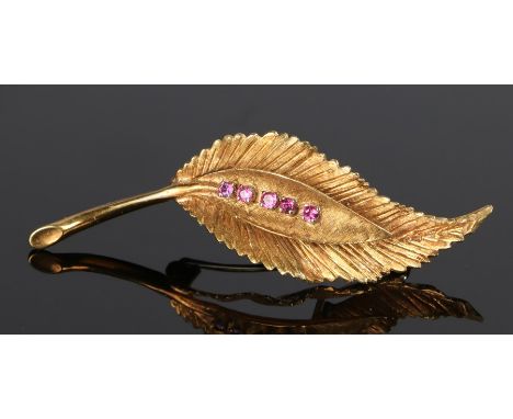 18 carat gold and ruby set brooch, in the form of a leaf with a row of rubies, 6.6 grams, 57mm diameter 