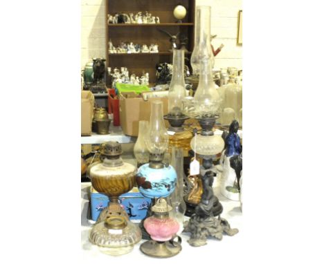A 19th century spelter oil lamp base in the form of a putto, with small cut-glass reservoir, 40cm high and a collection of oi