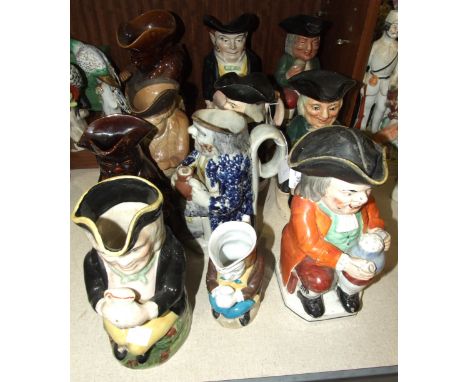 A collection of nine 19th century and later ceramic Toby jugs and two others, (damages and restoration), (11).