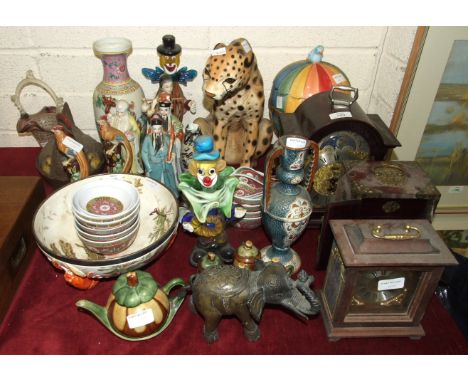 A Hermle wooden chiming mantel clock, 31cm high, various modern ceramic figure ornaments, two Murano glass clowns and miscell
