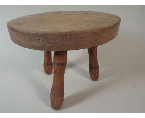 A Small Oval Elm Three Legged Stool, 26.5cm Long