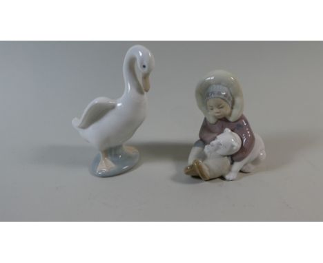 A Lladro Figurine Group of Eskimo and Nao Figurine of a Goose