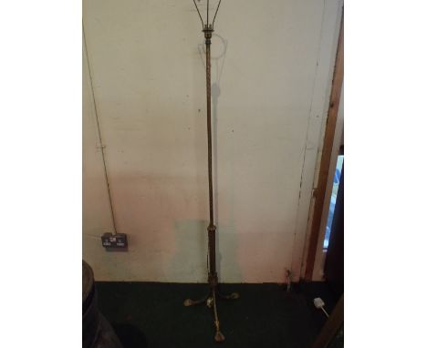 A Gilt Metal Tripod Based Standard Lamp