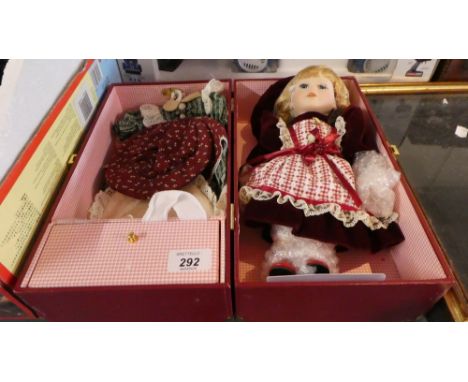 A Cased Ceramic Head Doll with Wardrobe, Clothes and Accessories