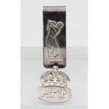 A silver money clip with golfer decoration and an ARP silver badge (2 27.5g)