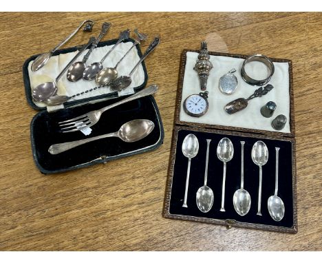 A mixed collection of silver, to include a cased 6 teaspoon set, a fob watch, a locket with inscription,  a baby rattle, a ca