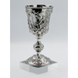A Victorian London silver cup, richly embossed with stylised flowers and cartouche, approx, 9.