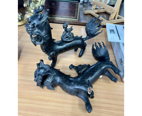 A pair of Chinese bronze mythological standing dragons, censor (faults- one leg detached). Length 36cm,