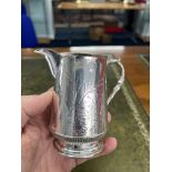 A Victorian silver cream jug, Sheffield, decorated with bird, butterfly and ferns, approx 5.94oz.