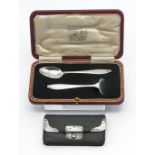 A silver baby spoon and pusher, weighs 31g, in fitted box. Together with a silver mounted vintage