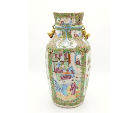 An early 19th century Chinese Canton famille rose vase, ovoid form with moulded linen fold decoration tied with an enamelled 