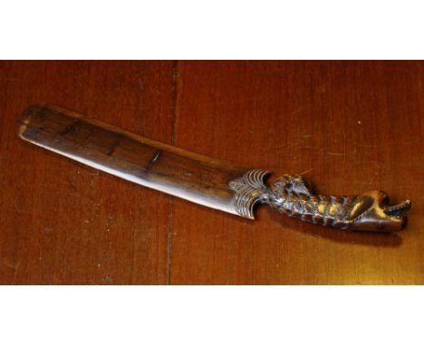 Treen - a carved yew wood paper knife, c.1880, the hilt with dog's head and fish scale body leading to the 6½in. blade, overa