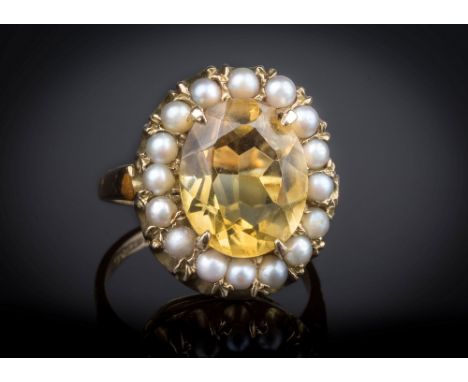 A Victorian style pale citrine and seed pearl cluster ring, London 1961, the oval cut citrine within a border of sixteen seed