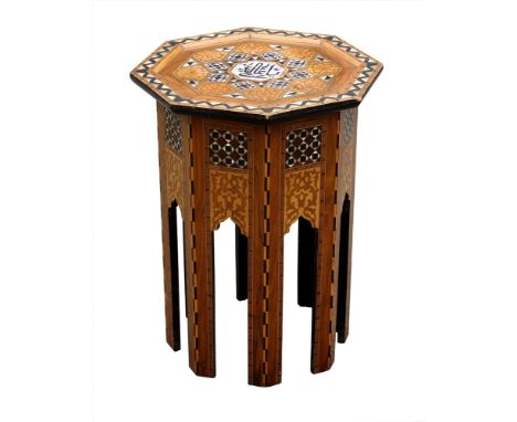 A Moorish inlaid octagonal table, early 20th century, the panelled top with parquetry, ebony and mother-of-pearl border enclo